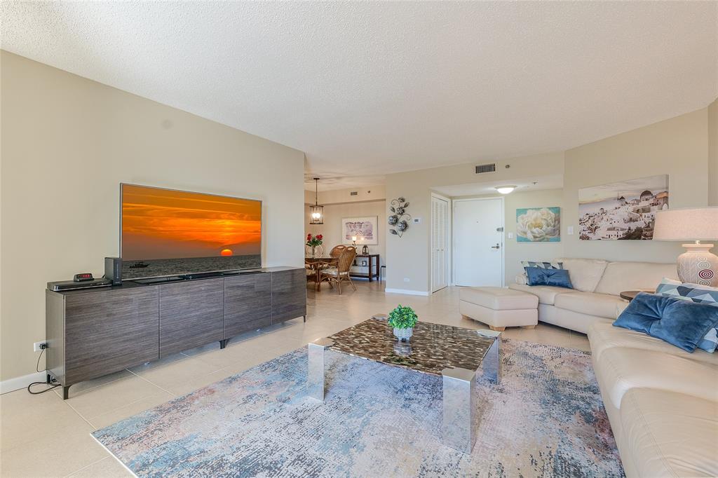 7200 Radice Court, Unit 705 Lauderhill, FL 33319 - Photo 5 of 54 a living room with furniture and a flat screen tv