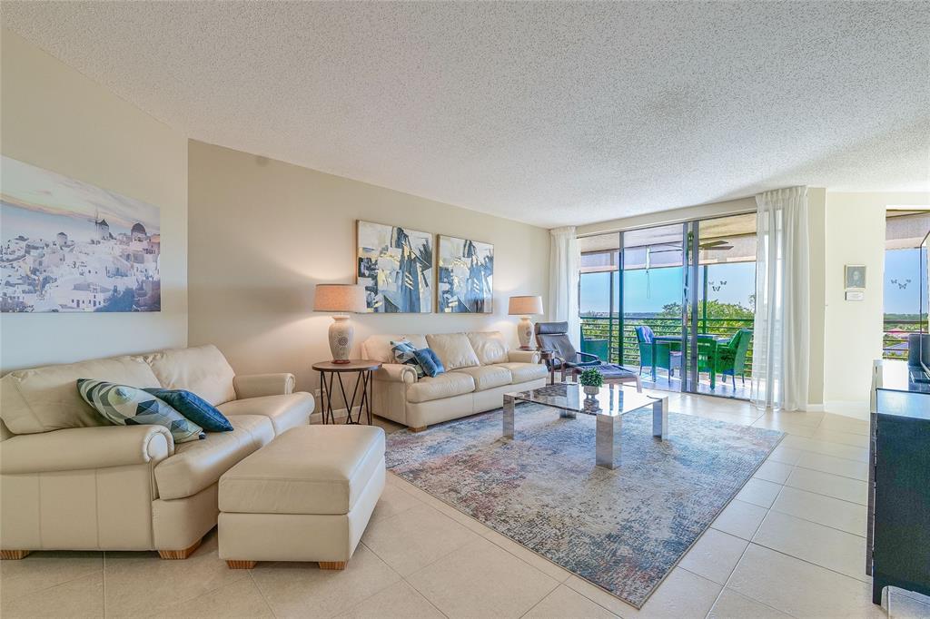 7200 Radice Court, Unit 705 Lauderhill, FL 33319 - Photo 6 of 54 a living room with furniture and a rug