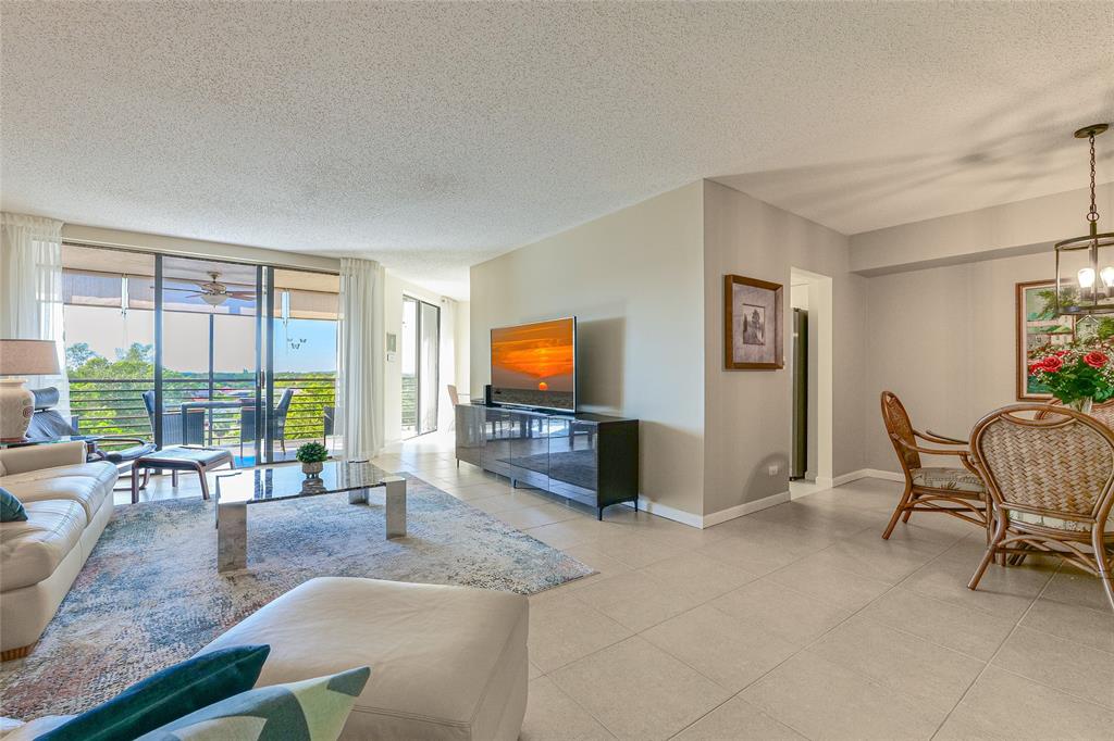 7200 Radice Court, Unit 705 Lauderhill, FL 33319 - Photo 7 of 54 a living room with furniture and a flat screen tv