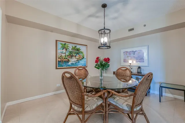 a view of a dining room with furniture a chandelier and window
