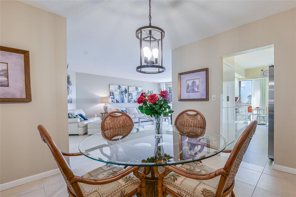 7200 Radice Court, Unit 705 Lauderhill, FL 33319 - Photo 9 of 54 a table room with furniture and potted plant