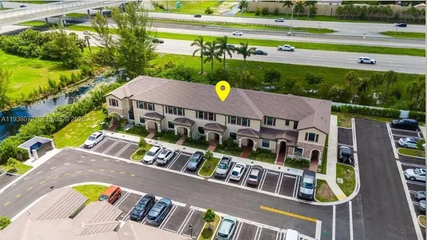 an aerial view of a house with a yard basket ball court and outdoor seating