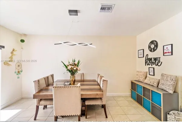 a dining room with furniture and wooden floor