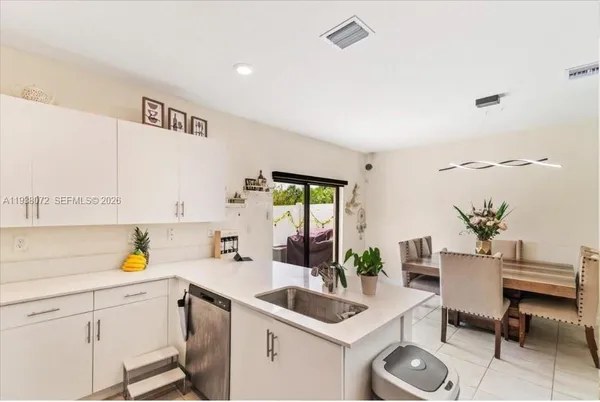 a kitchen with stainless steel appliances a refrigerator sink and microwave