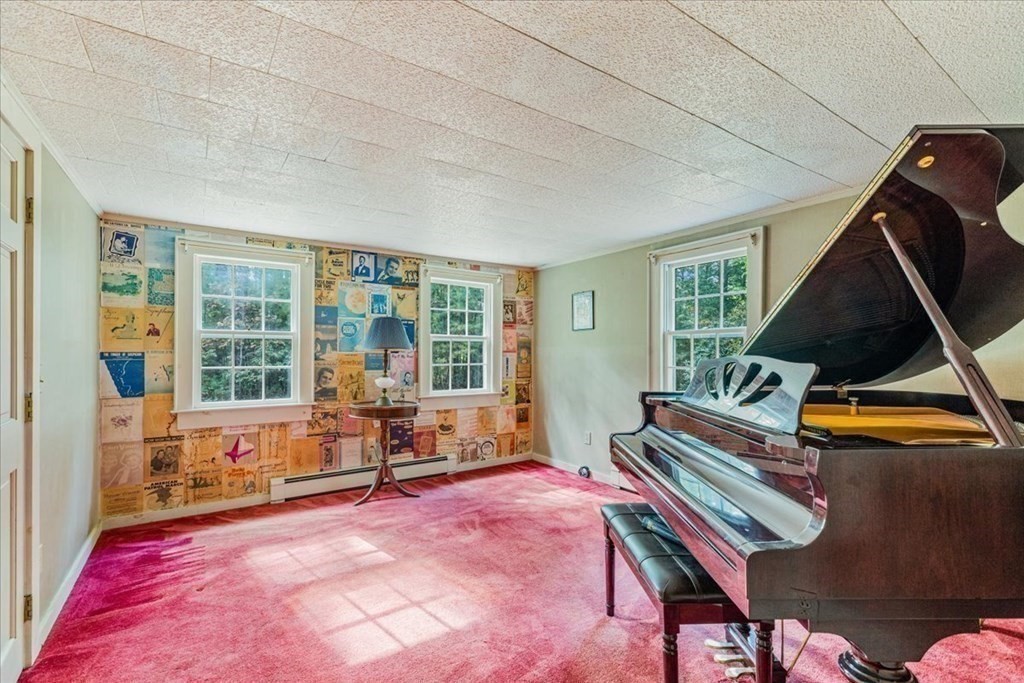 1 Robbins Path Carver, MA 02330 - Photo 14 of 42 a living room with a piano and a potted plant