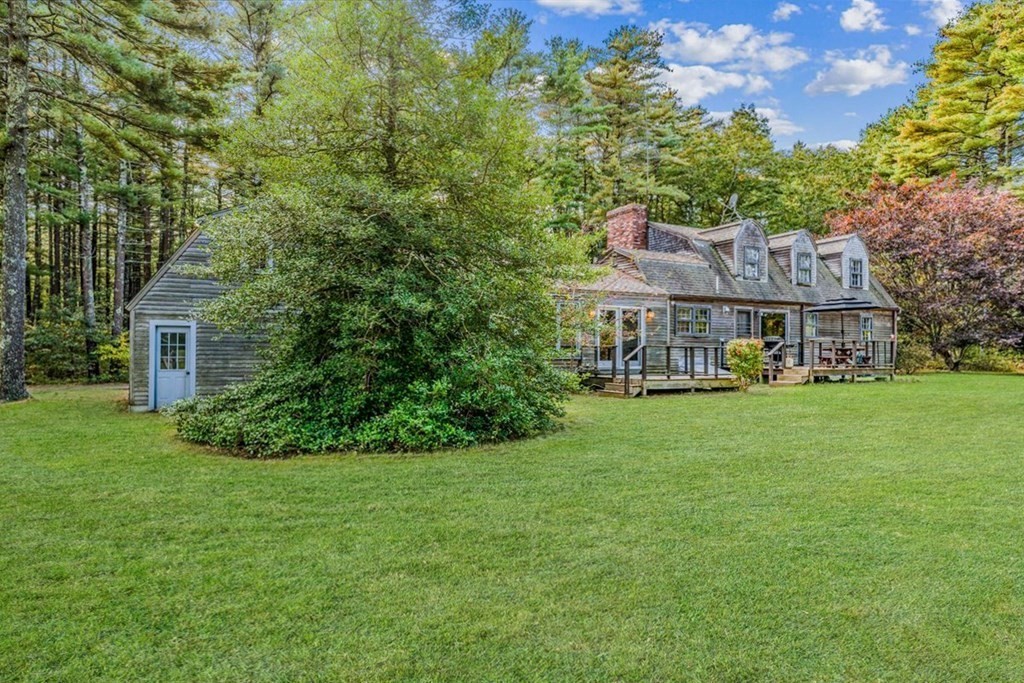1 Robbins Path Carver, MA 02330 - Photo 20 of 42 a front view of a house with a yard table and chairs