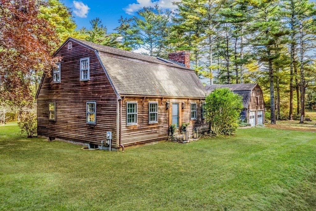 1 Robbins Path Carver, MA 02330 - Photo 2 of 42 a front view of a house with a yard