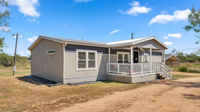 a view of house with a yard