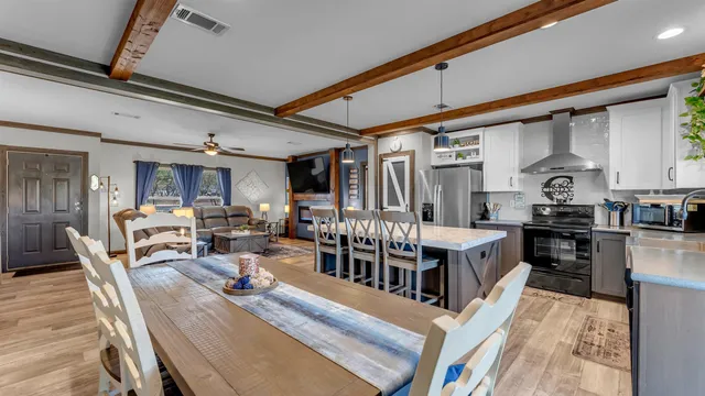 a living room with lots of wooden furniture and a dining table