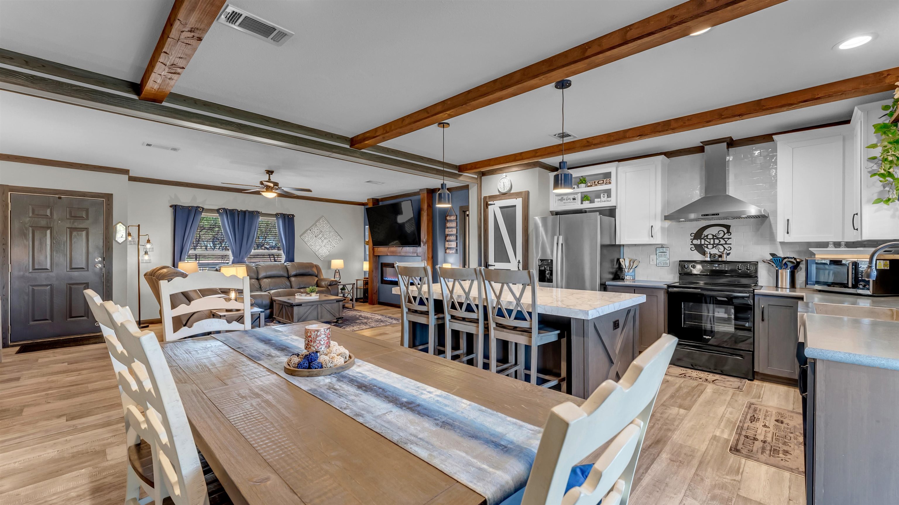321 Flag Creek Ranch Circle Llano, TX 78643 - Photo 11 of 30 a living room with lots of wooden furniture and a dining table