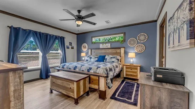 a bedroom with a bed and a chandelier