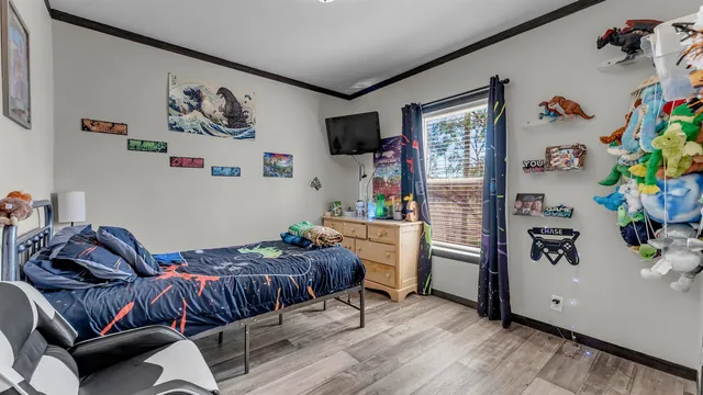 a bedroom with furniture and a flat screen tv
