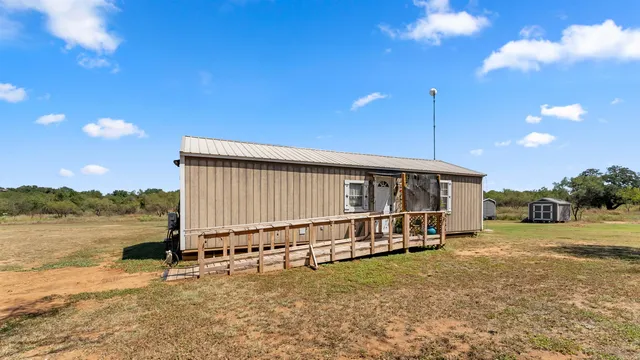 a view of a house with a yard and sitting area