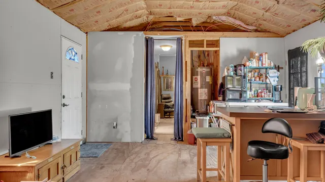 a dining room with furniture and a flat screen tv
