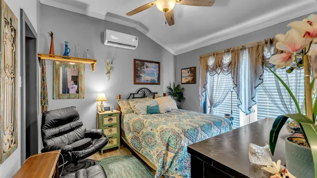 a bedroom with furniture and a large window