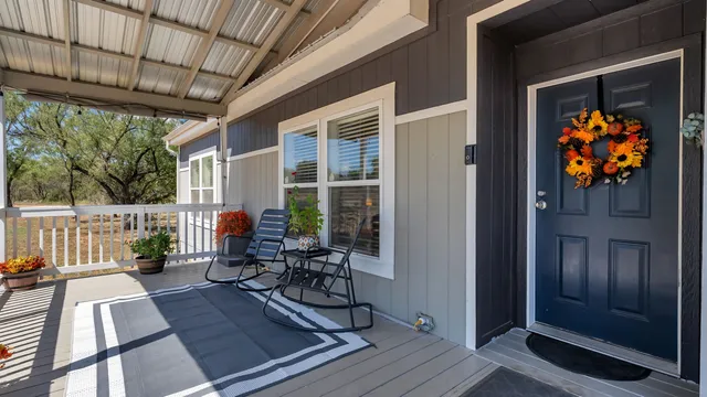 a view of balcony with furniture and wooden floor