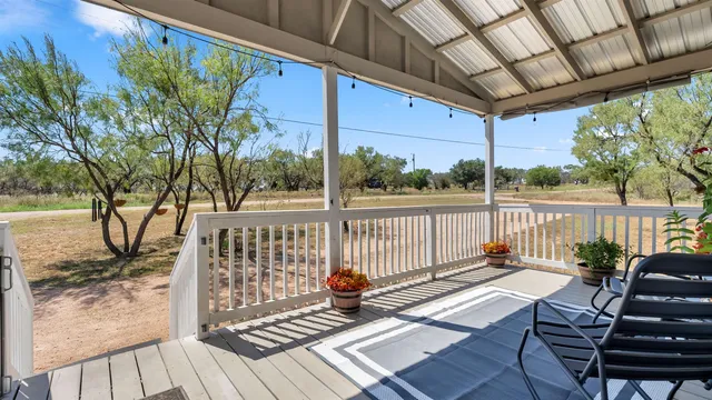 a view of balcony with wooden floor and outdoor seating