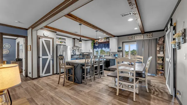 a view of a dining room with furniture and wooden floor