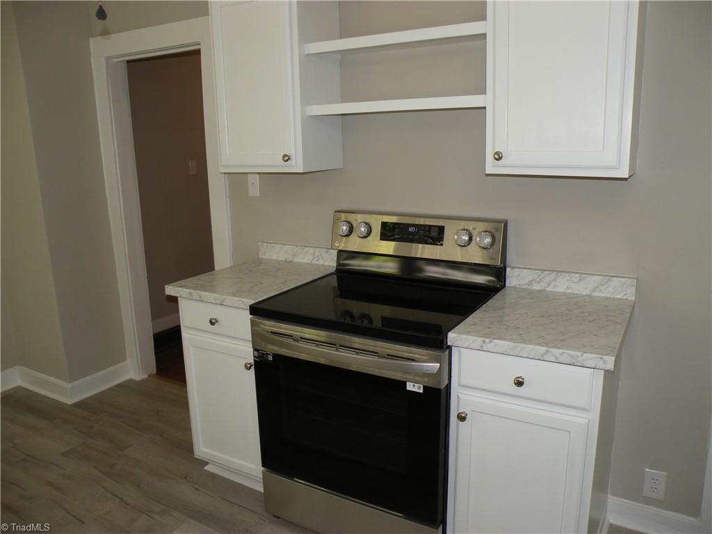 Kitchen - New stove and additional cabinetry