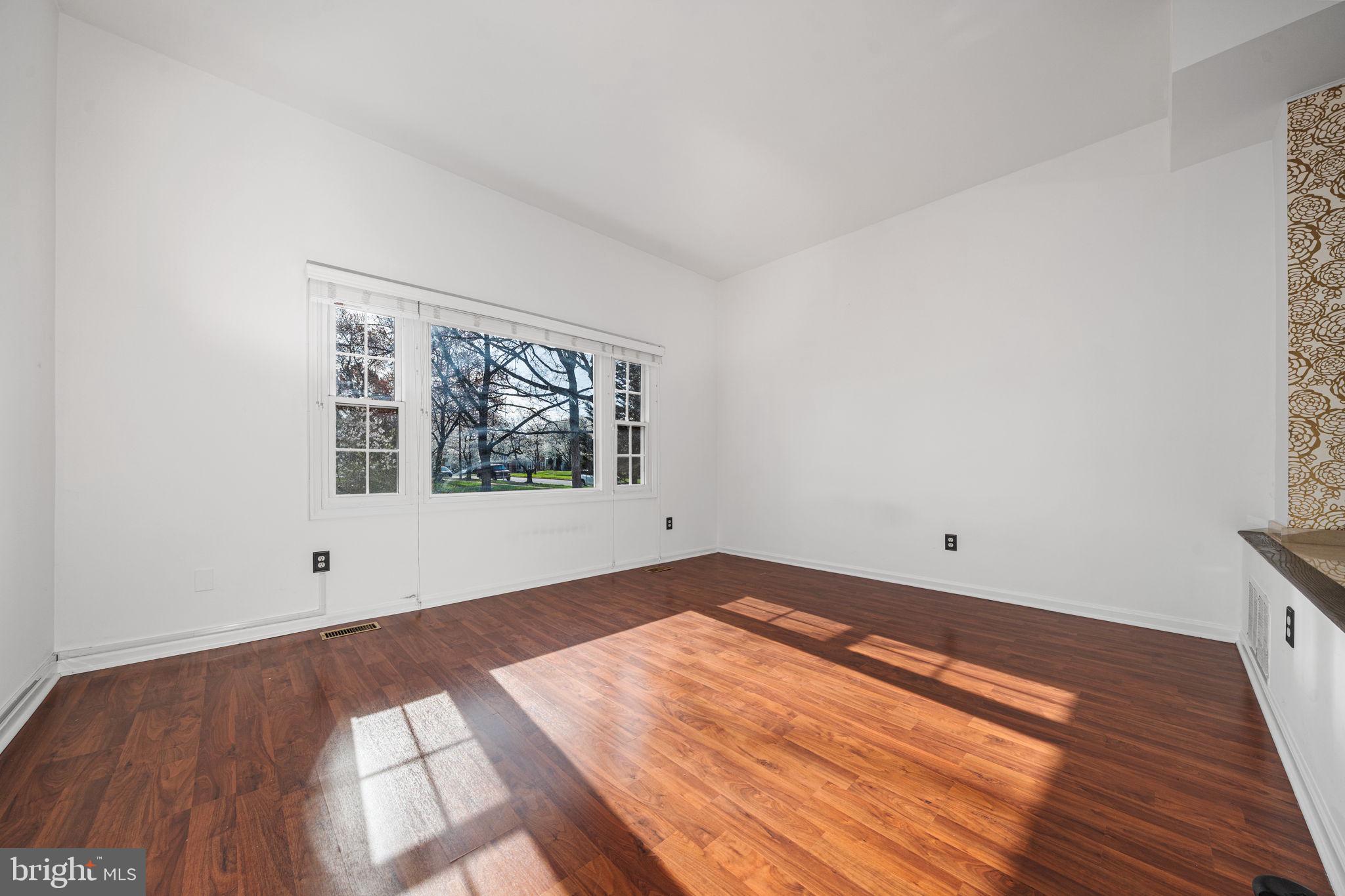 5845 Rexford Drive, Unit 721 Springfield, VA 22152 - Photo 11 of 32 an empty room with wooden floor and windows