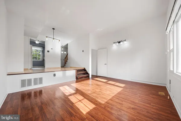 a spacious bathroom with a sink and a mirror