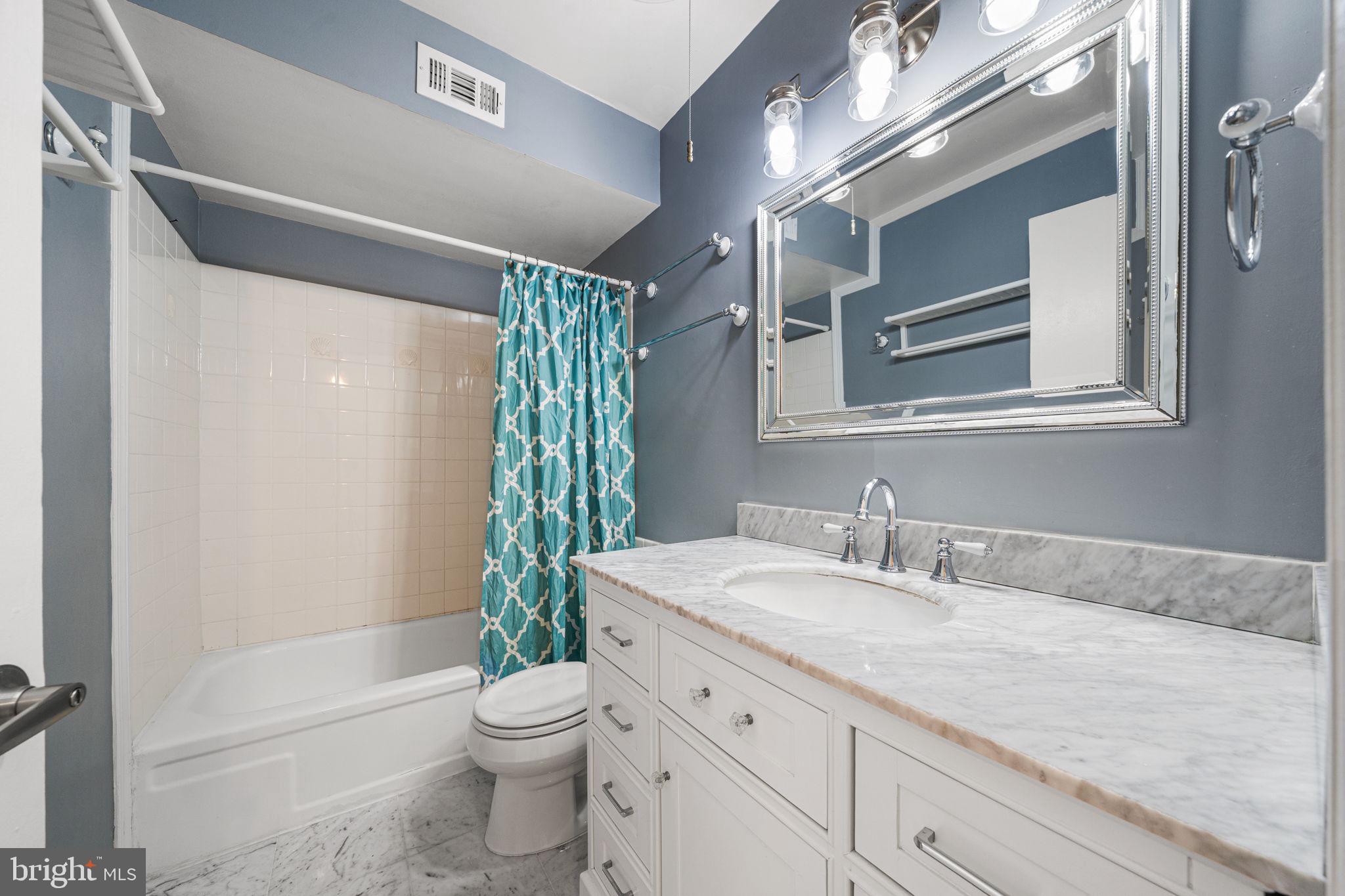 5845 Rexford Drive, Unit 721 Springfield, VA 22152 - Photo 18 of 32 a bathroom with a granite countertop sink toilet and shower
