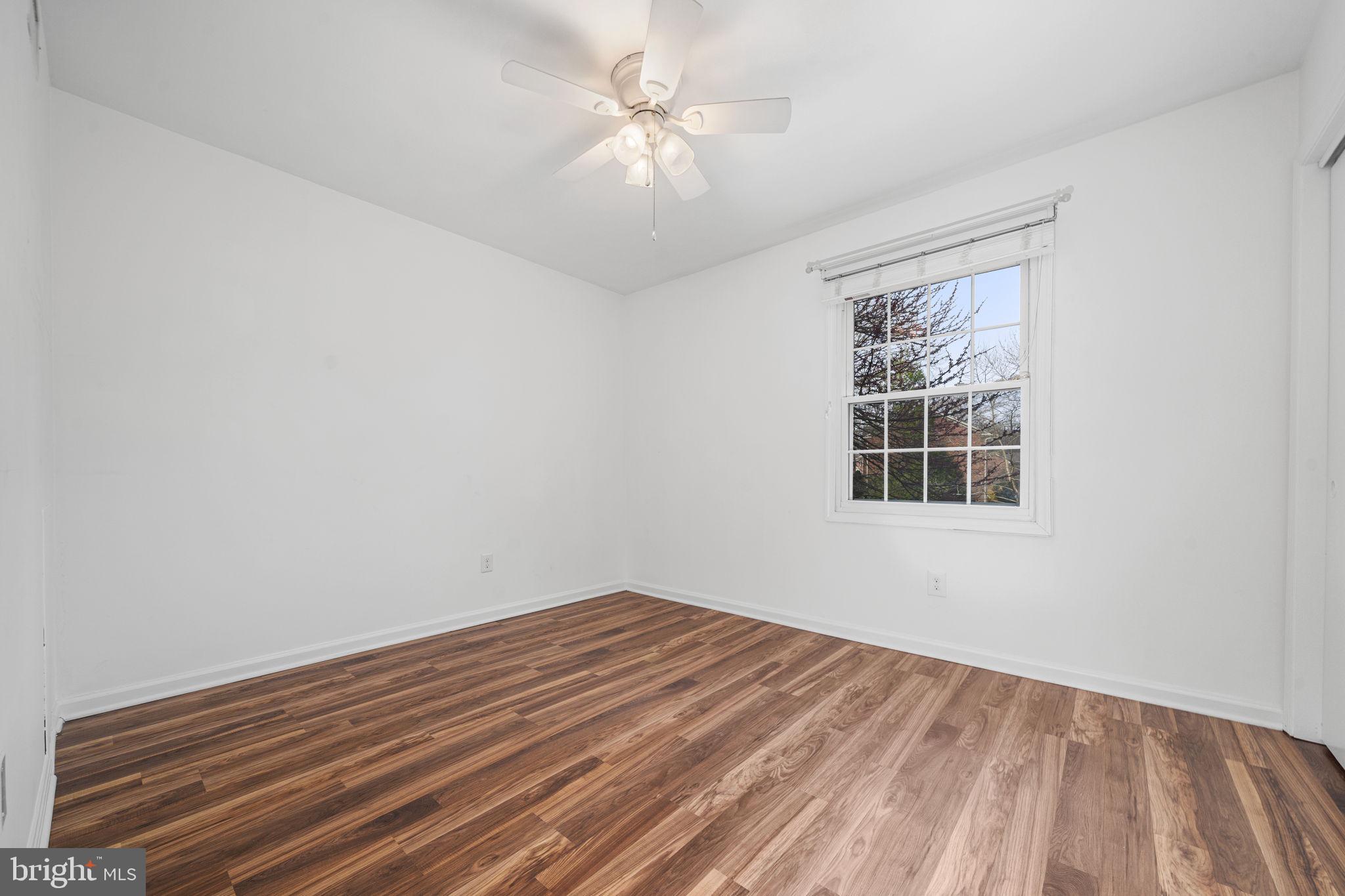 5845 Rexford Drive, Unit 721 Springfield, VA 22152 - Photo 19 of 32 a view of a room with wooden floor and a ceiling fan