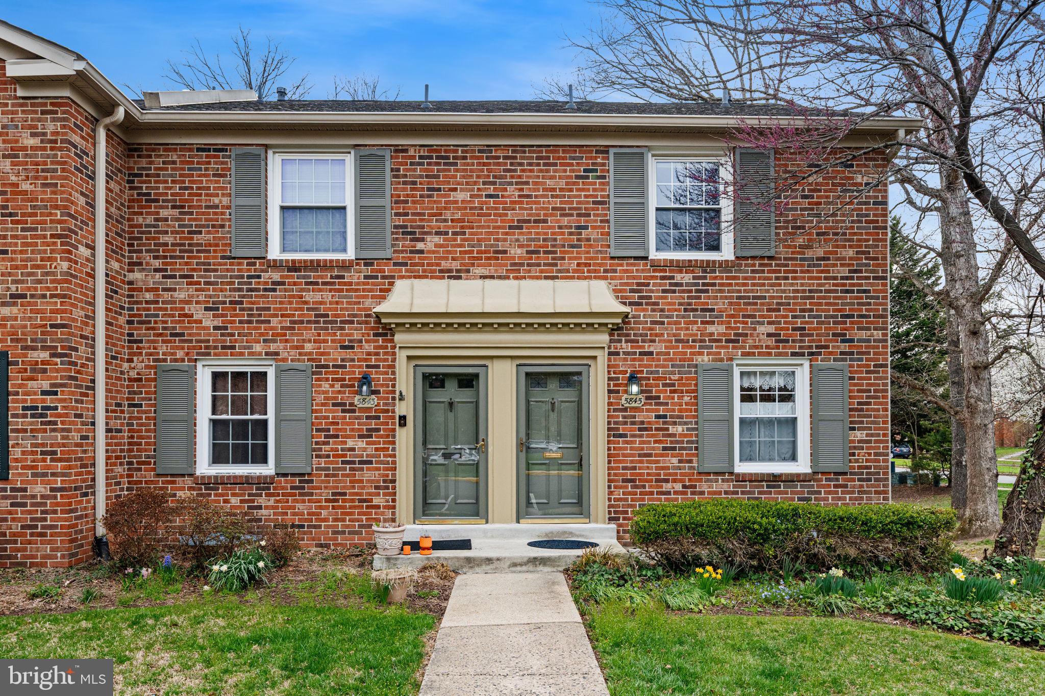 5845 Rexford Drive, Unit 721 Springfield, VA 22152 - Photo 2 of 32 a front view of a house with yard and garage