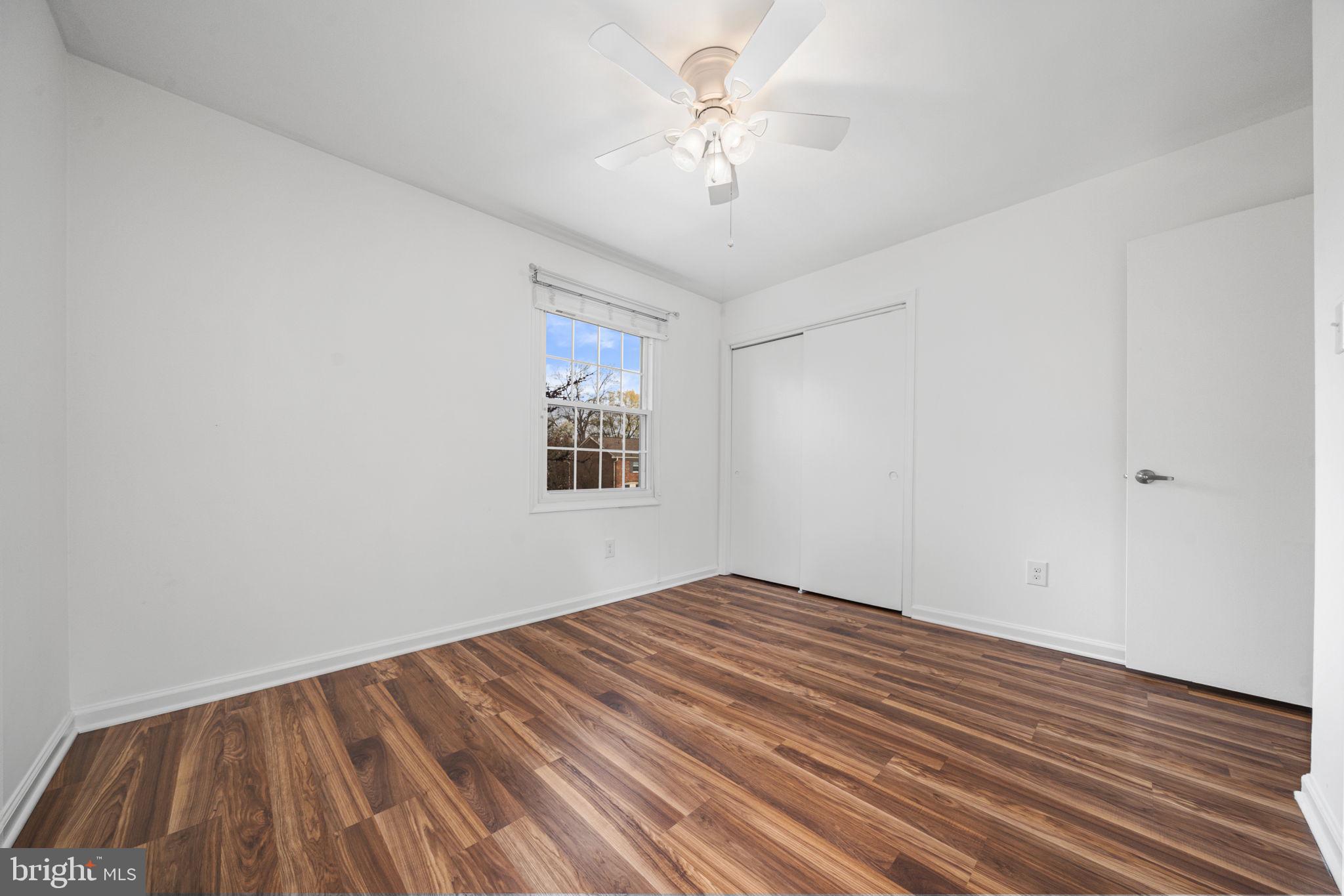 5845 Rexford Drive, Unit 721 Springfield, VA 22152 - Photo 21 of 32 a view of a room with wooden floor and a ceiling fan