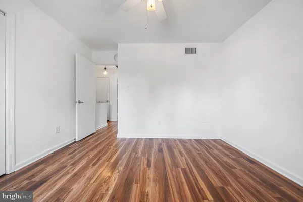 a view of a room with wooden floor and a sink