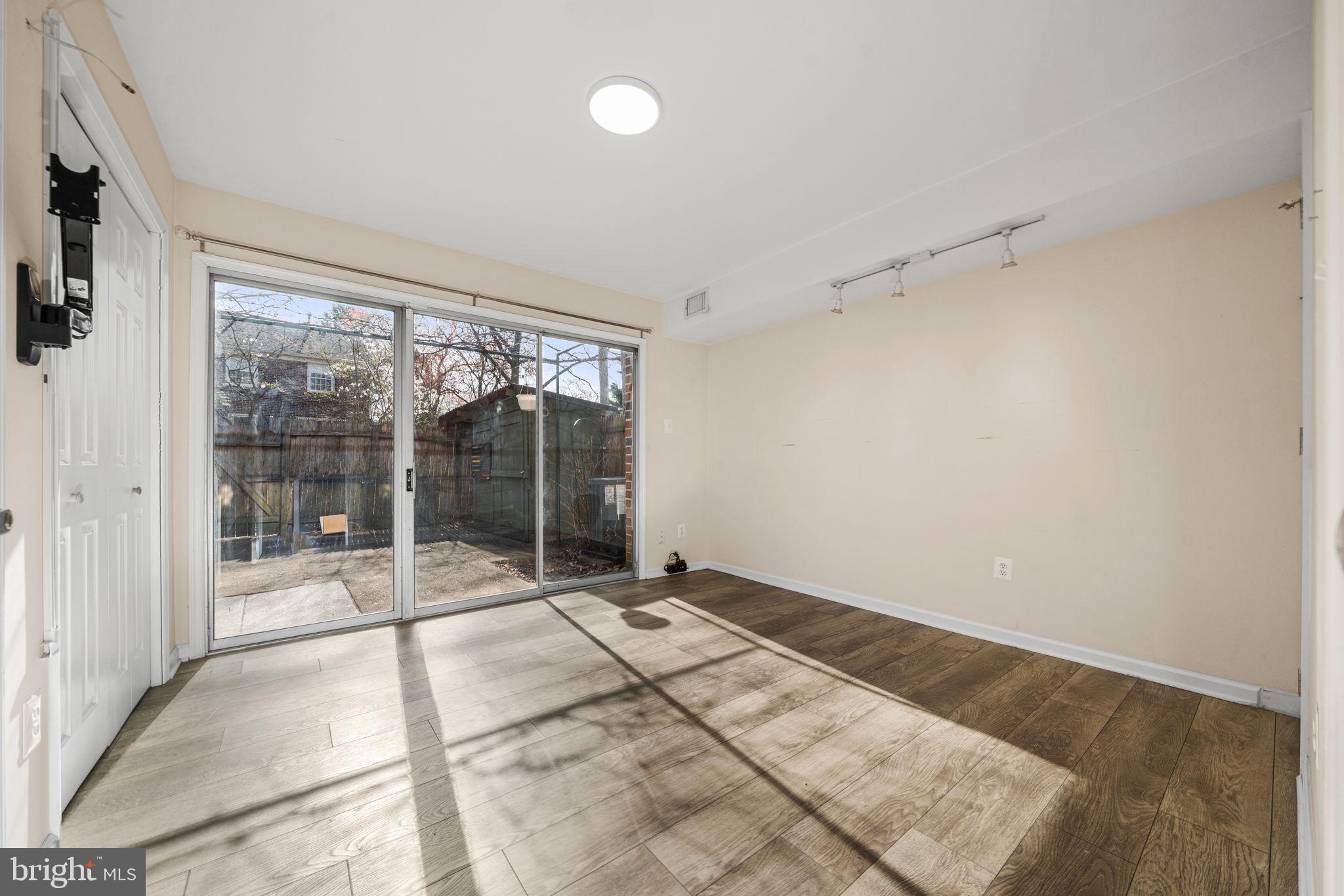 5845 Rexford Drive, Unit 721 Springfield, VA 22152 - Photo 23 of 32 a view of an empty room with a floor to ceiling window and a flat screen tv