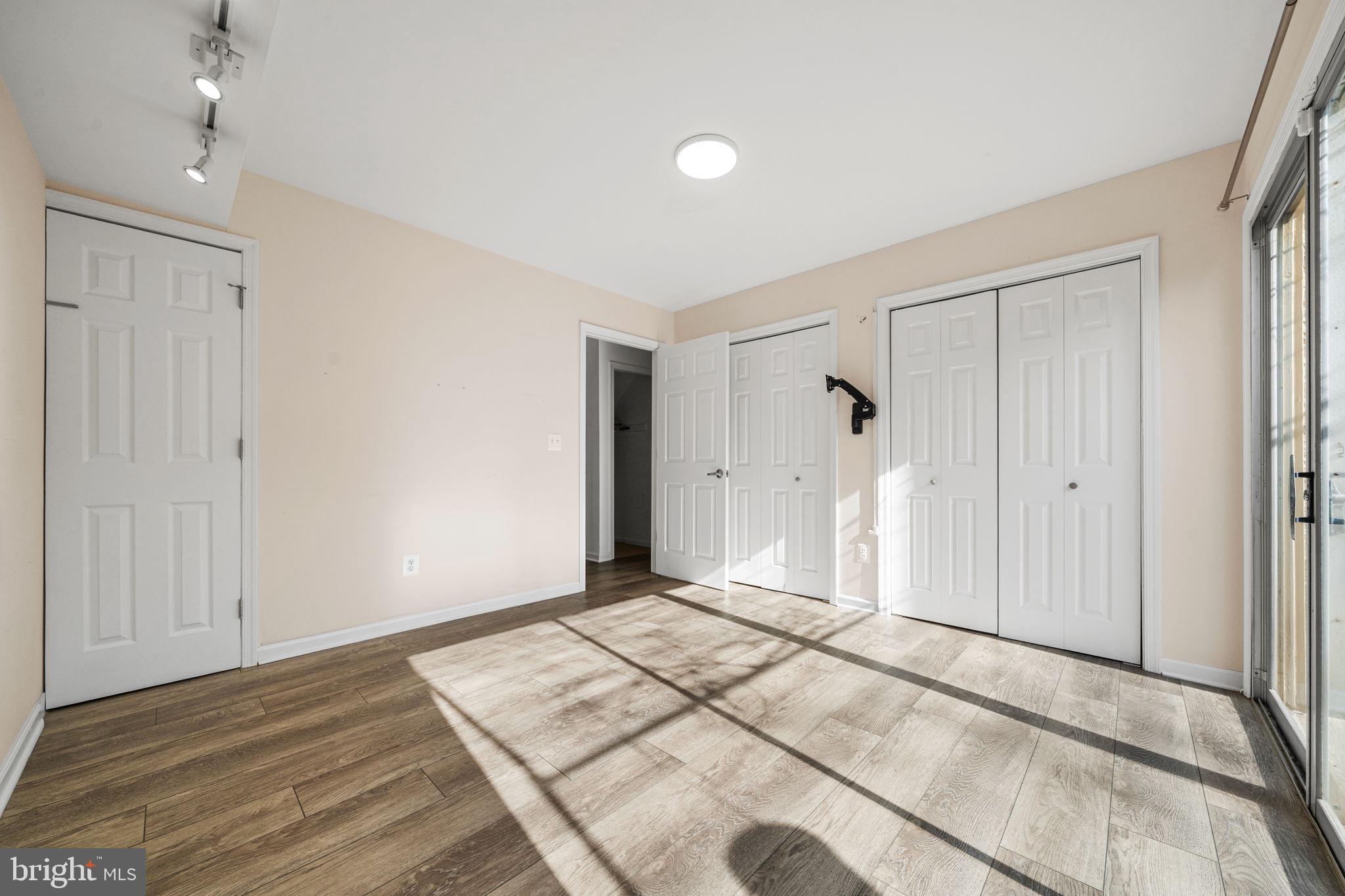 5845 Rexford Drive, Unit 721 Springfield, VA 22152 - Photo 24 of 32 a view of a livingroom with wooden floor and a ceiling fan