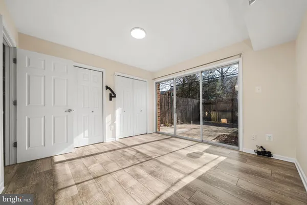 a view of a room with wooden floor and a rug