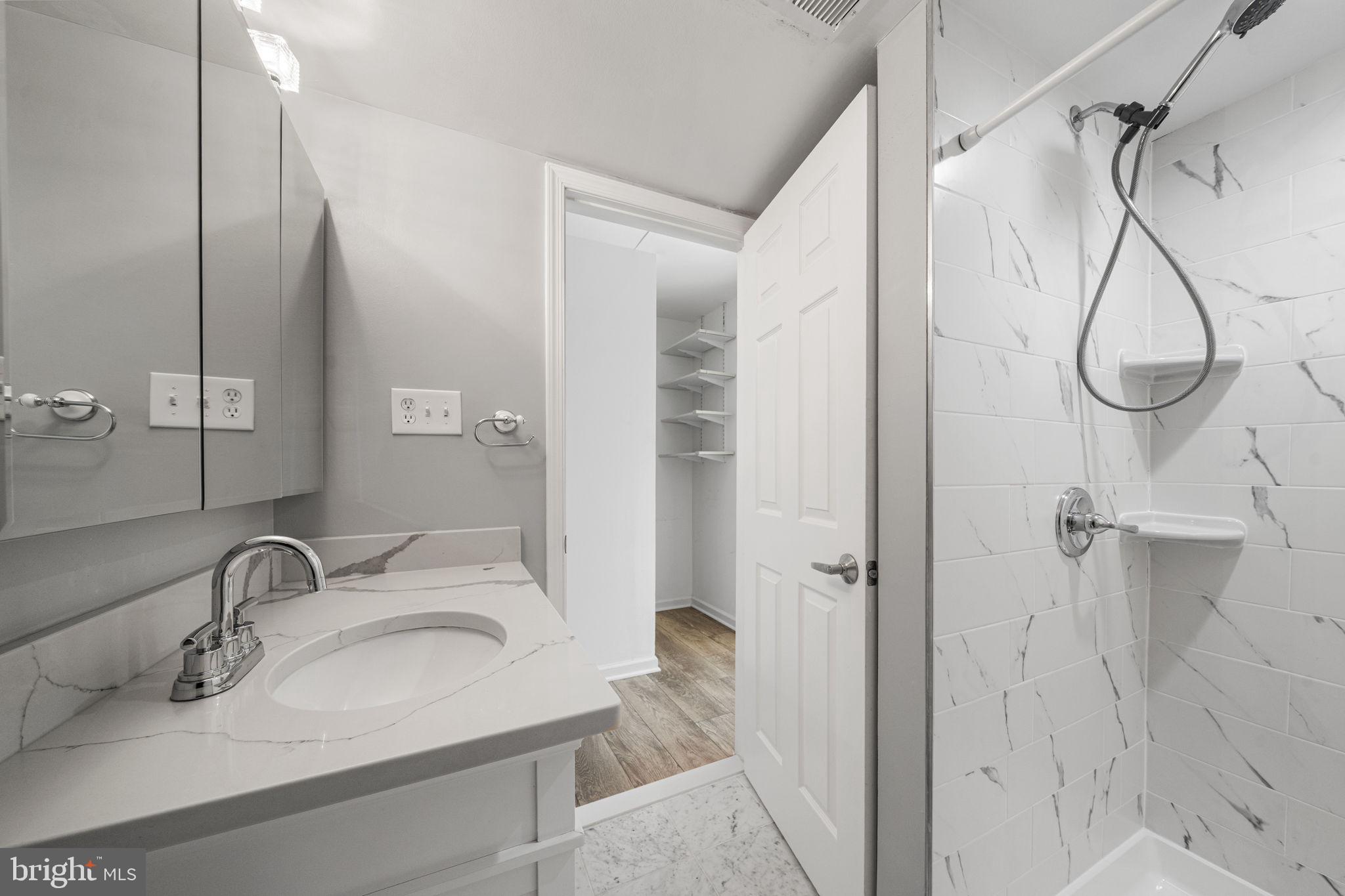5845 Rexford Drive, Unit 721 Springfield, VA 22152 - Photo 27 of 32 a bathroom with a sink and a mirror