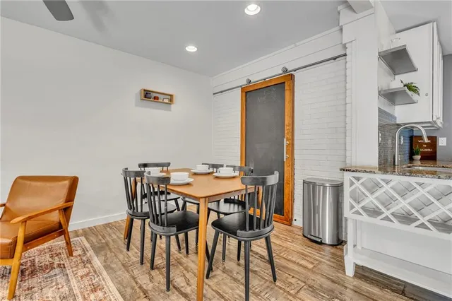 a view of a dining room with furniture and wooden floor