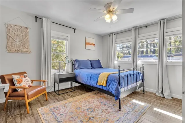 a bed sitting in a bedroom next to a window