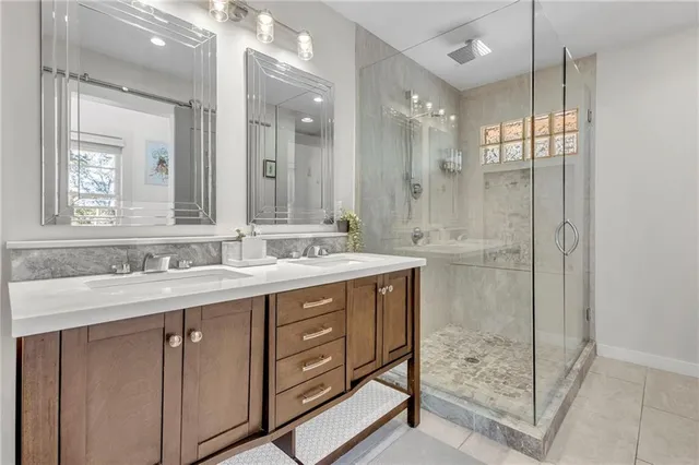 a bathroom with a shower sink and mirror