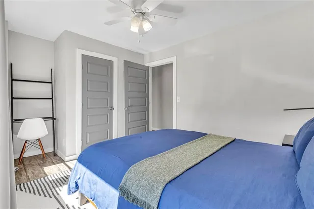 a bedroom with a bed and a chandelier