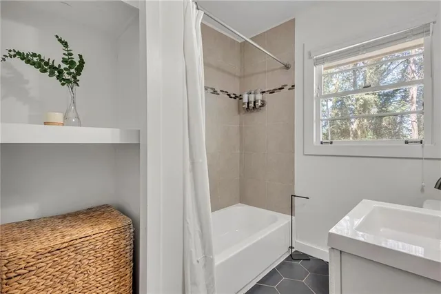 a bathroom with a tub and a sink