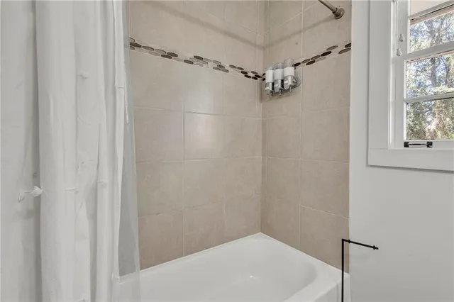 a bathroom with a shower and a window