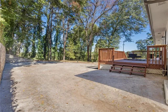 a backyard of a house with barbeque oven and outdoor seating