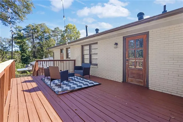 a view of a roof deck with wooden floor and fence