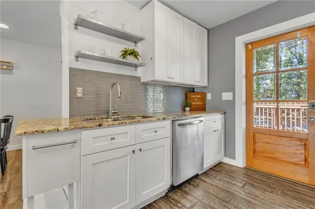 a spacious bathroom with a granite countertop sink and a window