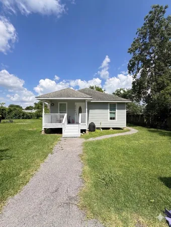 a front view of a house with a yard and porch