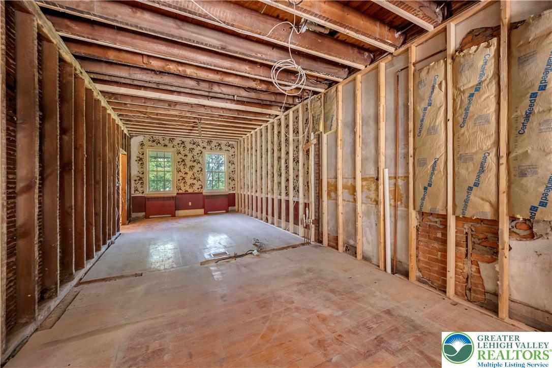 384 Henry Road Nazareth, PA 18064 - Photo 31 of 54 Exposed framing and structural timbers outline a spacious room ready for customized renovation.