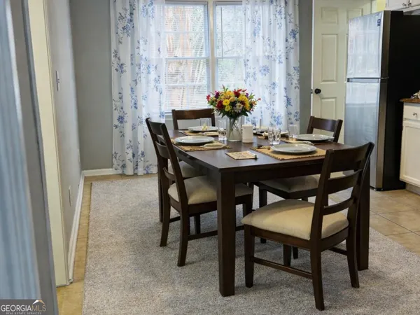 a view of a dining room with furniture and a potted plant