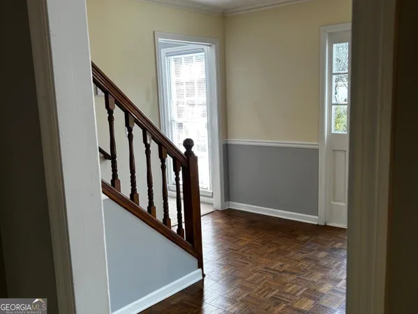 a view of an entryway with wooden floor