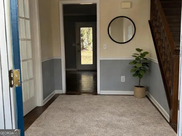 a view of a room with wooden floor and a window