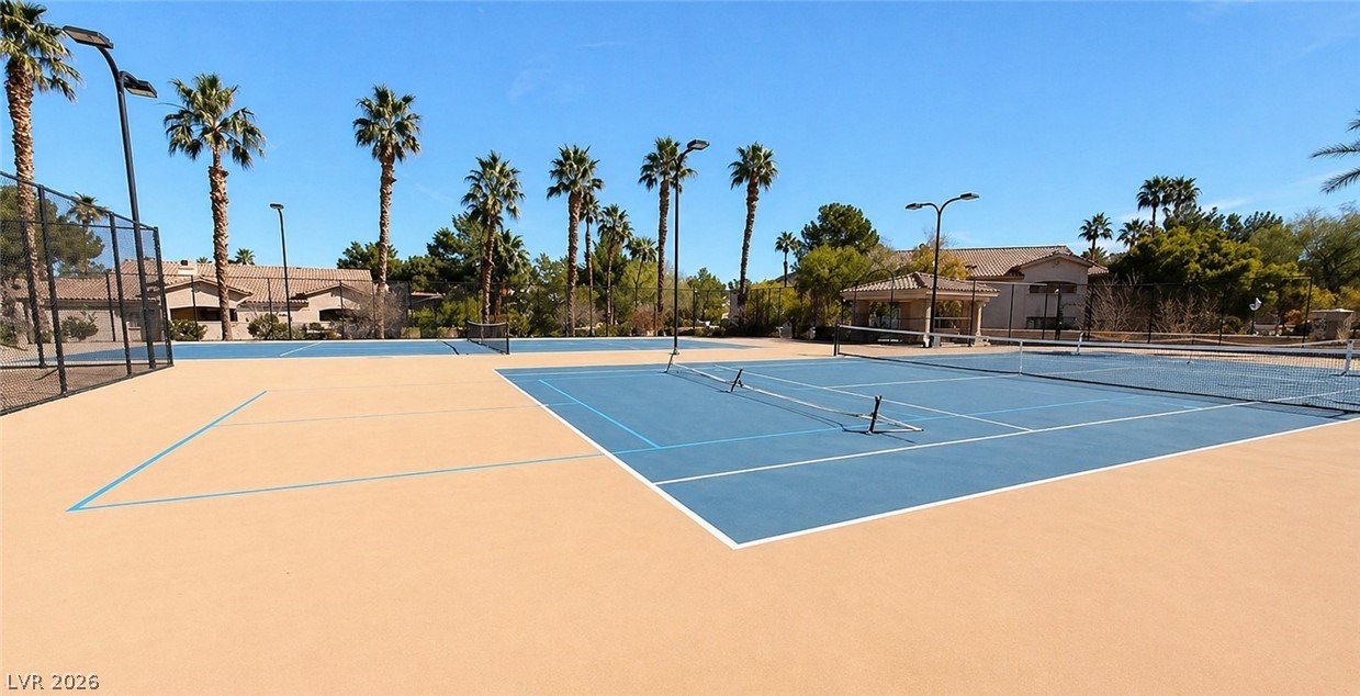 2050 West Warm Springs Road, Unit 2422 Henderson, NV 89014 - Photo 44 of 44 Enjoy lively matches on these inviting blue and tan tennis courts, framed by palm trees.