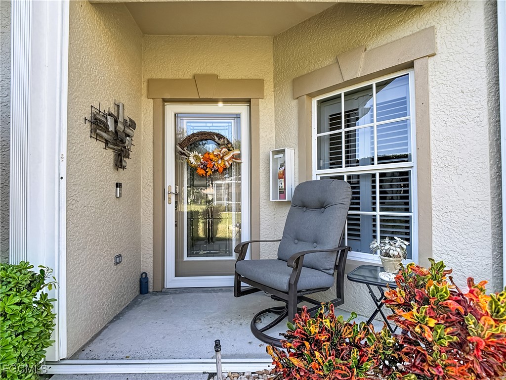 3630 Rue Alec Loop, Unit 1 North Fort Myers, FL 33917 - Photo 2 of 50 a balcony with couple of chairs and a potted plant